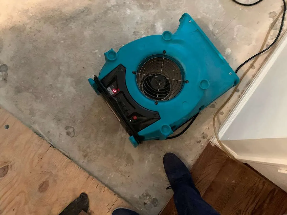 Air mover drying subfloor during Leak Detection & Repair in Hellam